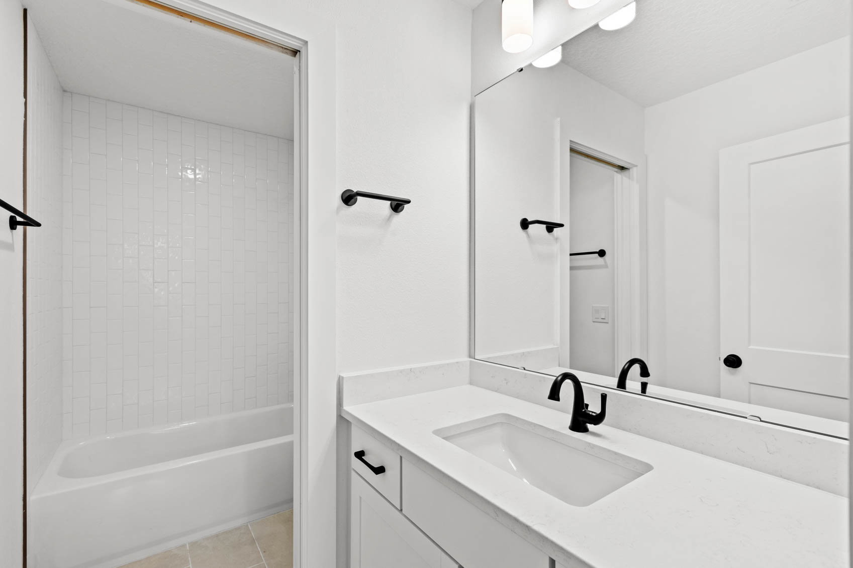 bathroom with white walls and sink cabinet and shower